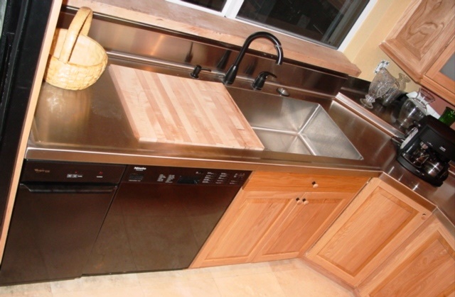 Stainless steel countertop with built-in sink and cutting board
